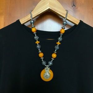 Amber-like and silver tone beaded necklace